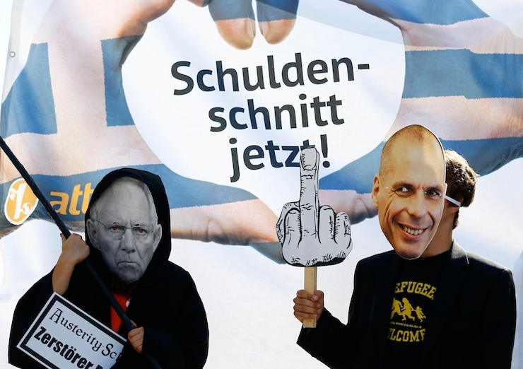 Demonstrators wearing the masks depicting German Finance Minister Schaeuble and former Greek Finance Minister Varoufakis take part in a protest outside the European Central Bank headquarters in Frankfurt