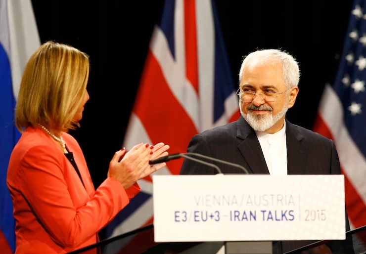 High Representative of the European Union for Foreign Affairs and Security Policy Mogherini applauds Iranian FM Zarif during a joint news conference after a plenary session at the United Nations building in Vienna