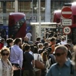 Commuters wait for buses at Victoria Station in London