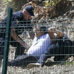Police detain a protester during unrest at a ceremony marking the 20th anniversary of the Srebrenica massacre in Potocari