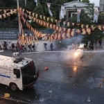 Riot police use water cannon as demonstrators throw fireworks during a protest in central Istanbul, Turkey