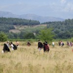 Migrants run towards Gevgelija in Macedonia after crossing Greece's border