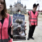 A performer holds a brochure for 'Dismaland', a theme park-styled art  installation by British artist Banksy, at Weston-Super-Mare in southwest England