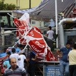 People stand among debris after an attack on a nearby police station in Istanbul