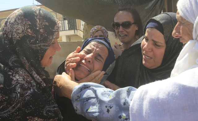 Relatives of Palestinian Saad Dawabsheh mourn during his funeral in Duma village near Nablus