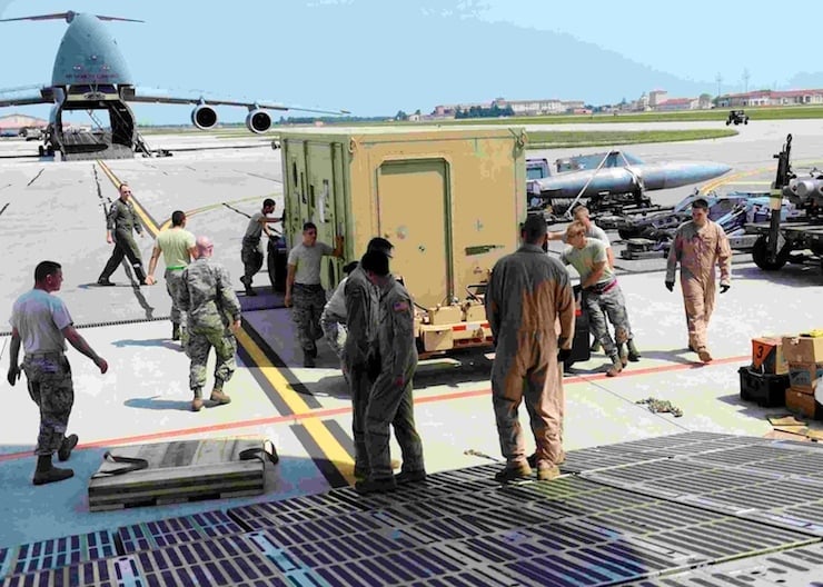 Airmen from the 436th Airlift Wing and 724th Air Mobility Squadron load cargo onto a C-5 Super Galaxy at Aviano Air Base, Italy