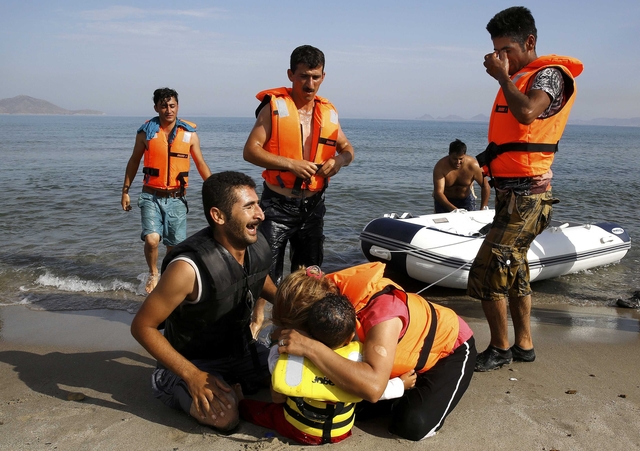 Iranian migrants arrive at the Greek island of Kos on a dinghy
