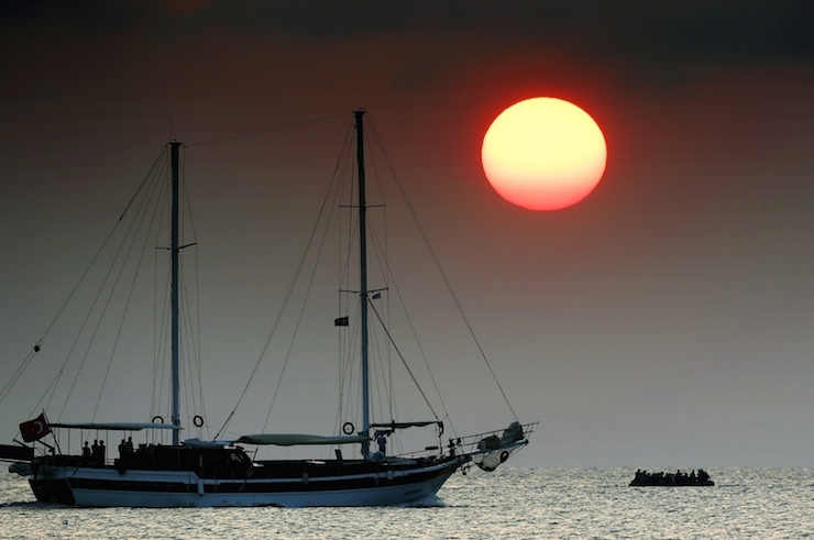 Syrian refugees on a dinghy drift in the Aegean sea off the Greek island of Kos in Greece