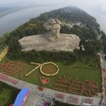 Participants gather in front of a statue of China's late Chairman Mao in his youth, during an event to celebrate the 70th anniversary of the end of World War Two in Changsha
