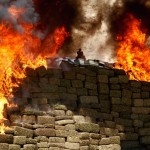 A burning pile of marijuana and other drugs are being incinerated at a camp of the Mexican Army's 28th infantry battalion in Tijuana