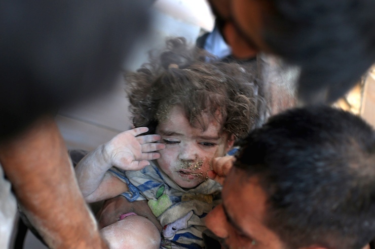 A medic carries an injured girl that survived from under debris caused by what activists said was barrel bombs dropped by forces loyal to Syria's President Bashar Al-Assad in Douma, Eastern Al-Ghouta, near Damascus, Syria