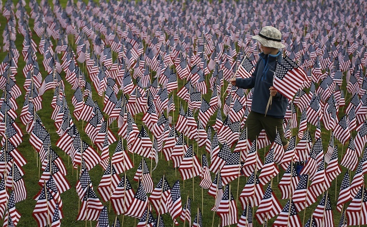 A boy walks among some of the 3,000 flags placed in memory of the lives lost in the September 11, 2001 attacks, at a park in Winnetka, Illinois, September 10, 2015. On Friday people will mark the 14th anniversary of the 9/11 attacks. REUTERS/Jim Young TPX IMAGES OF THE DAY