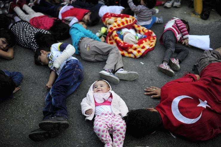 Migrants protest as they are stopped by security forces at a bus station in Istanbul