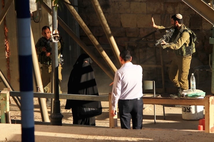 Israeli soldiers aim their rifles at 19-year-old Palestinian student Hadeel al-Hashlamun before being shot at an Israeli checkpoint in the occupied West Bank city of Hebron