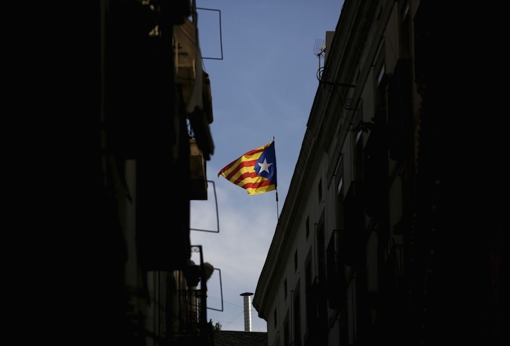 "Estelada" flag, a symbol of Catalonian pro-independence, flutters on top of a building in Barcelona, Spain