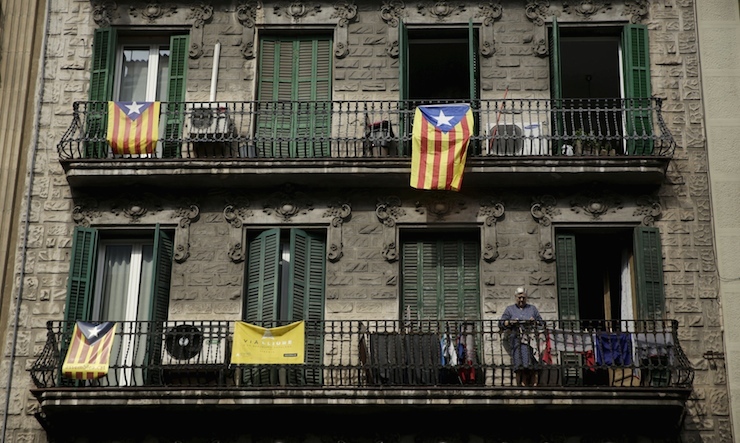 "Estelada" flags, a symbol of Catalonian pro-independence, hang from balconies of a building in Barcelona, Spain, September 26, 2015. Catalonia, a region that speaks its own language and accounts for about one fifth of Spanish economic output and population, votes on Sunday to elect a new parliament. Separatist parties running on a joint ticket are expected to win a majority of seats, according to polls. They say they will unilaterally declare independence within 18 months if they win. REUTERS/Andrea Comas