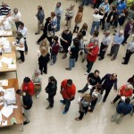 People line up to cast their ballots at a polling station during a regional parliamentary election in Barcelona