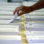 A man picks up his ballot before voting in Catalonia's regional parliamentary election in Barcelona