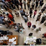 People line up to cast their ballots at a polling station during a regional parliamentary election in Barcelona