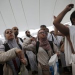 Muslim pilgrims cast stones at pillars symbolizing Satan, during the annual Haj pilgrimage on Eid al-Adha in Mina, near the holy city of Mecca