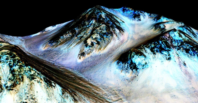 Dark, narrow, 100 meter-long streaks on Mars inferred to have been formed by contemporary flowing water are seen in a NASA handout image