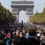 People walk on the Champs-Elysees as central Paris goes car-free on Sunday