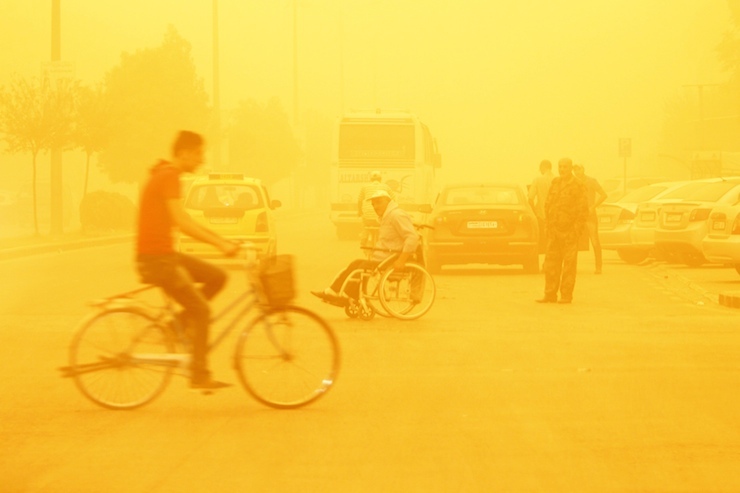 A man rides a bicycle through a sandstorm in Homs, Syria September 7, 2015. REUTERS/Omar Sanadiki TPX IMAGES OF THE DAY