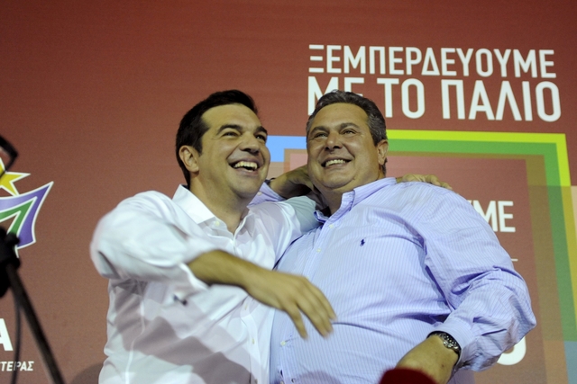 Former Greek prime minister and leader of leftist Syriza party Alexis Tsipras hugs coalition partner and leader of the Independent Greeks party, Panos Kammenos after winning the general election in Athens