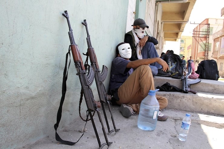 File photo of members of YDG-H, youth wing of the outlawed Kurdistan Workers Party, sitting next to their weapons in Silvan