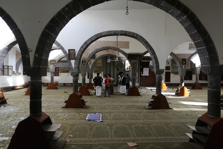 People gather inside the al-Balili mosque after two bombings hit the mosque in Yemen's capital Sanaa