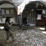 Houthi militant walks inside the al-Balili mosque after two bombings hit the mosque in Yemen's capital Sanaa