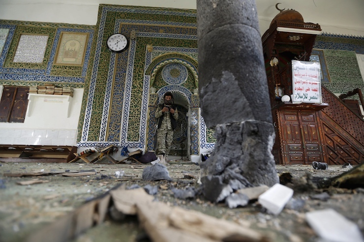 Houthi militant stands inside the al-Balili mosque after two bombings hit the mosque in Yemen's capital Sanaa