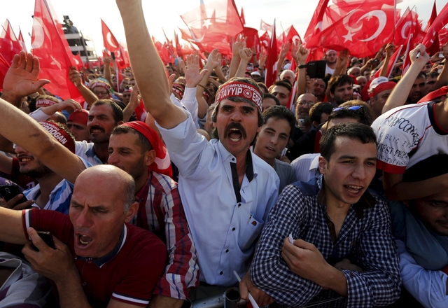 Men wave Turkey's national flags during a rally against recent Kurdish militant attacks on Turkish security forces in Istanbul