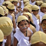 School children dressed as Mahatma Gandhi take part in an attempt to set a world record during celebrations to mark the 146th birth anniversary of Gandhi in Bengaluru