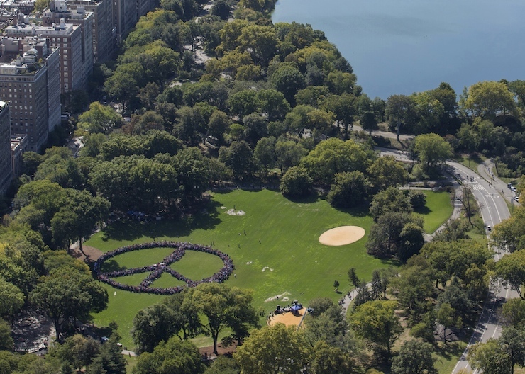 People create a human peace sign during an event to celebrate what would have been the 75th birthday of former Beatle musician John Lennon, organised by his widow Yoko Ono and the John Lennon Educational Tour Bus, in Central Park, New York, October 6, 2015, as seen in this aerial photo provided by NYonAir/Paul GaNun. REUTERS/NYonAir/Paul GaNun/Handout via Reuters ATTENTION EDITORS - THIS PICTURE WAS PROVIDED BY A THIRD PARTY. REUTERS IS UNABLE TO INDEPENDENTLY VERIFY THE AUTHENTICITY, CONTENT, LOCATION OR DATE OF THIS IMAGE. NO SALES. FOR EDITORIAL USE ONLY. NOT FOR SALE FOR MARKETING OR ADVERTISING CAMPAIGNS. THIS PICTURE WAS PROCESSED BY REUTERS TO ENHANCE QUALITY. AN UNPROCESSED VERSION WILL BE PROVIDED SEPARATELY. TPX IMAGES OF THE DAY