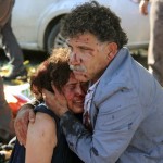 An injured man hugs an injured woman after an explosion during a peace march in Ankara