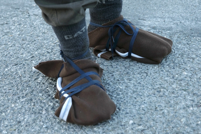 The feet of Iranian refugee Youssef, 33-years-old, that are wrapped in pieces cut from clothing, are seen a road close to the "new jungle" in Calais, France, October 3, 2015. Youssef reportedly walked 10 kilometers through the Channel Tunnel overnight, before being stopped by police and security. Around 200 migrants tried to get into the Channel Tunnel in France overnight, clashing with staff and police and forcing the suspension of rails services a spokesman for Eurotunnel said. Around 3,000 migrants fleeing war and poverty in Africa and the Middle East are camped on the French side of the tunnel in Calais, trying to board vehicles heading for Britain via the tunnel and on ferries or by walking through the tunnel, even though security measures aimed at keeping them out have been stepped up. REUTERS/Pascal Rossignol