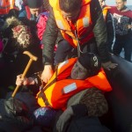 A Syrian refugee woman arrives with other Syrians on an overcrowded dinghy on the Greek island of Lesbos, after crossing a part of the Aegean Sea from the Turkish coast