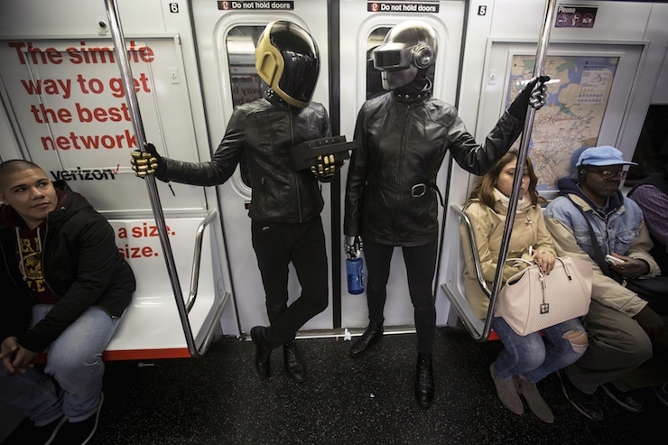 A couple dressed up as musical act Daft Punk ride the shuttle subway at Times Square station in the Manhattan borough of New York, October 31, 2015. REUTERS/Carlo Allegri TPX IMAGES OF THE DAY