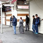 Police take security measures as locals stand around during an operation in Sur district, where an unidentified gunman on Saturday killed a top Kurdish lawyer, in the Kurdish-dominated southeastern city of Diyarbakir