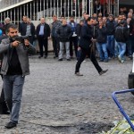 A plainclothes police officer aims his weapon during an operation in Sur district, where an unidentified gunman on Saturday killed a top Kurdish lawyer, in the Kurdish-dominated southeastern city of Diyarbakir