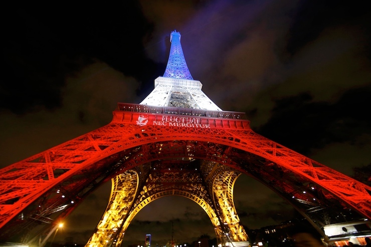 The Eiffel Tower is lit with the blue, white and red colours of the French flag in Paris to pay tribute to the victims of a series of deadly attacks on Friday in the French capital