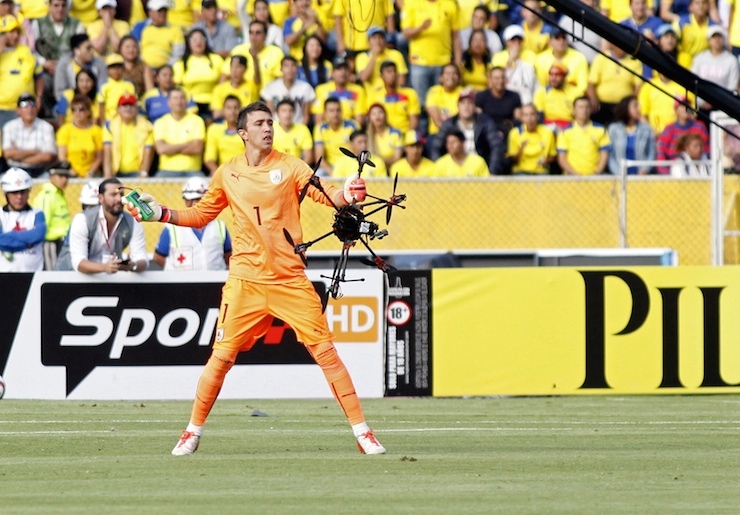 Uruguay goalkeeper Fernando Muslera holds a drone which fell on the field during their 2018 World Cup qualifying soccer match against Ecuador at Atahualpa stadium in Quito, November 12, 2015. REUTERS/Gary Granja TPX IMAGES OF THE DAY
