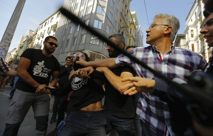 Plainclothes police officers disperse LGBT rights activists before a Gay Pride Parade in central Istanbul, Turkey