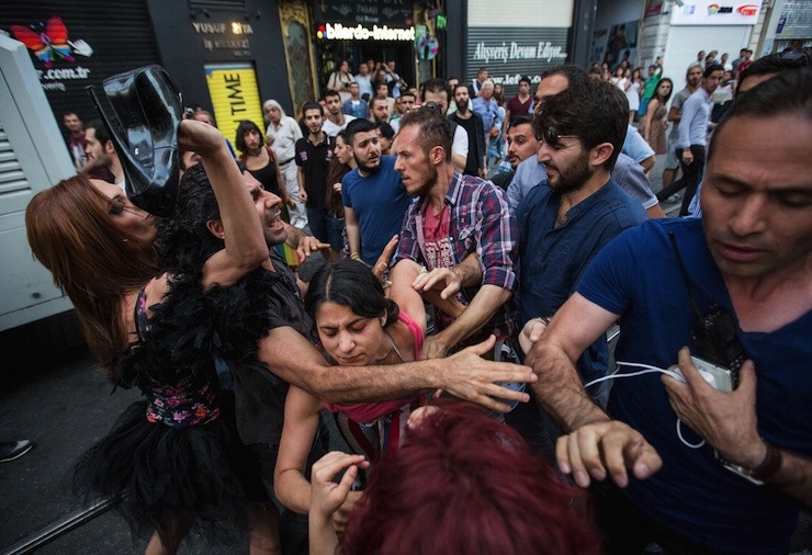 LGBT rights activists struggle with plainclothes police officers before a Gay Pride Parade in central Istanbul, Turkey