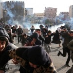 Riot police fire tear gas to disperse demonstrators during a protest against the curfew in Sur district, in the southeastern city of Diyarbakir, Turkey