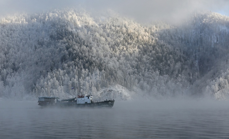 Motor boat sails along Yenisei River outside Krasnoyarsk
