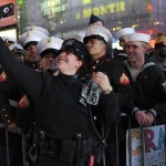 New York Police Department officer Nydia Rodriguez takes a selfie with members of the U.S. Marine Corps and U.S. Navy during New Year's celebrations in Times Square