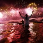 A couple watch as fireworks explode over Copacabana beach during New Year celebrations in Rio de Janeiro