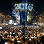 Revellers gather near the Arc de Triomphe on the Champs Elysees Avenue in Paris during New Year celebrations